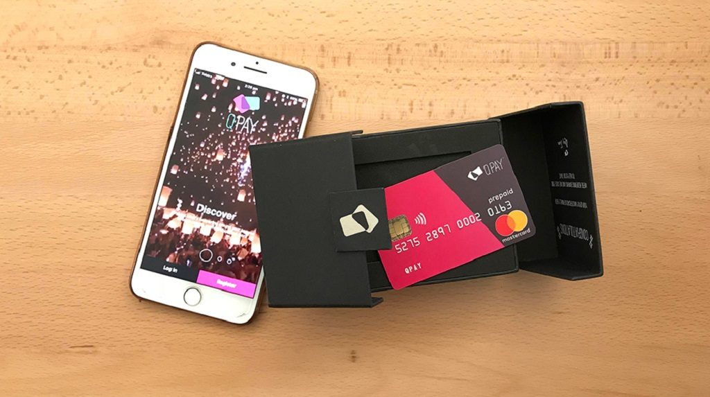 QPay Swipe Mobile phone with the QPay app loaded and the new QPay mastercard on a table,