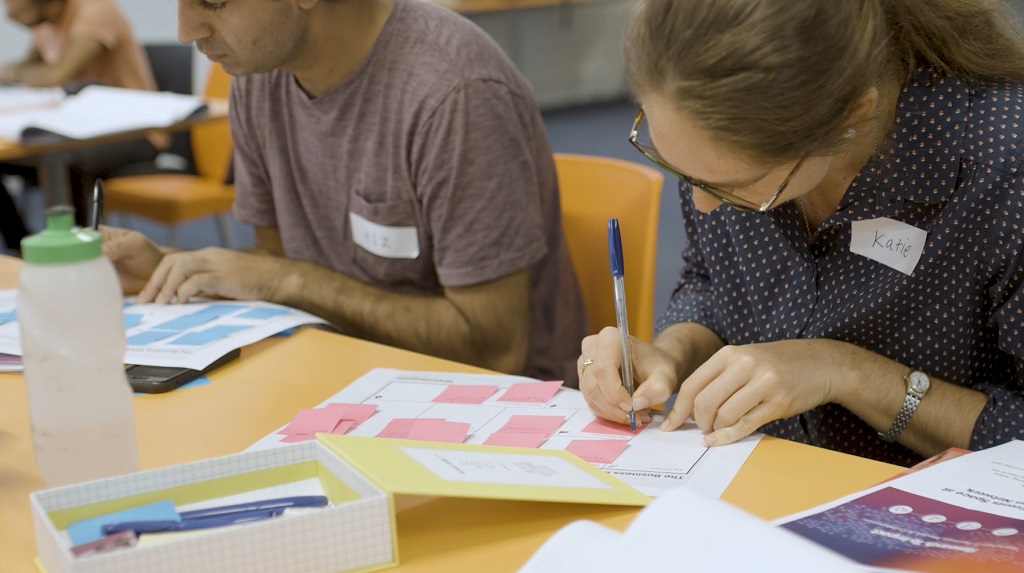 Researcher writes on canvas in workshop