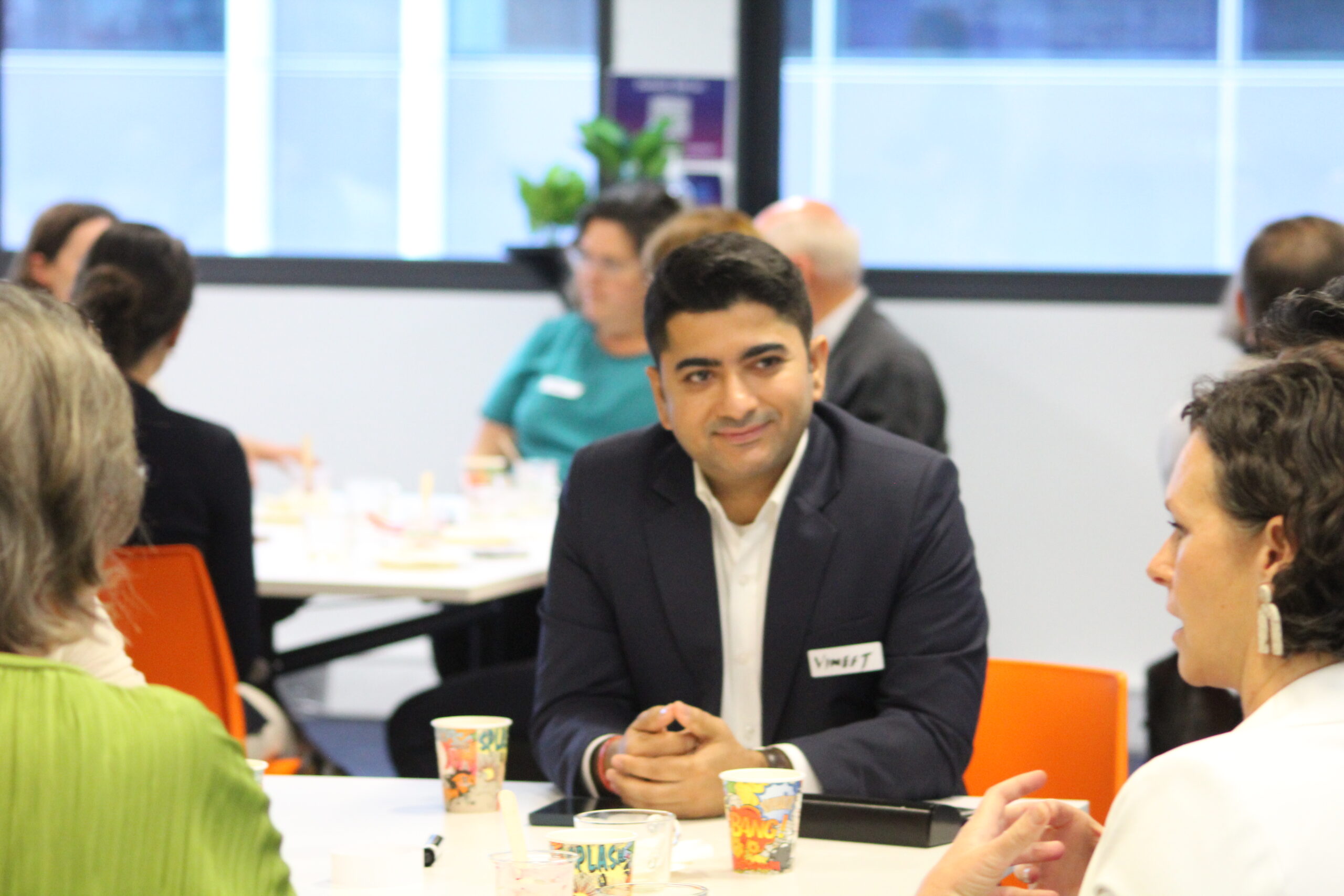 SME Breakfast Photo Person in suit listening at breakfast